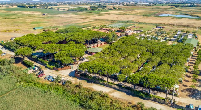 Panoramica di un campeggio con alberi e terreni agricoli.